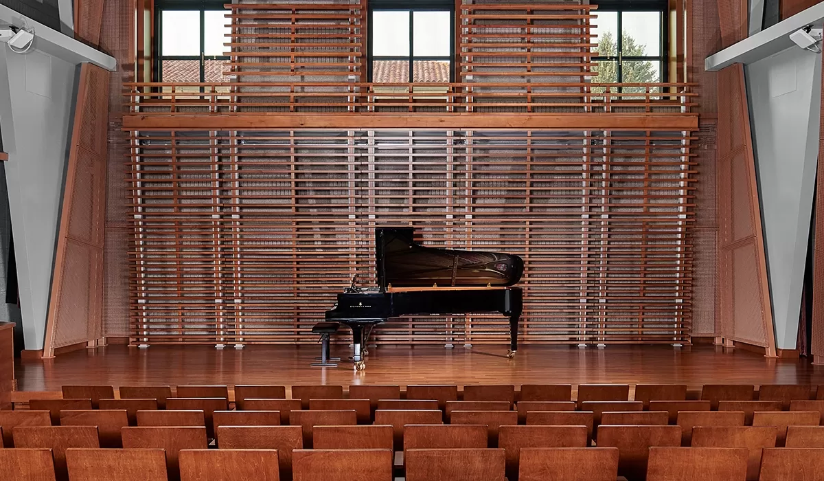 Interior of Chamber Hall (S102) with a grand piano on a polished wooden stage