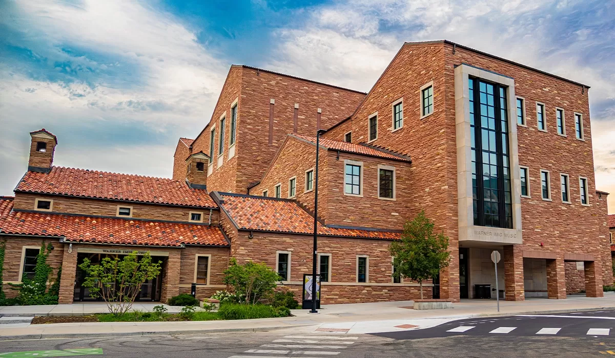 Large contemporary building with red stone exterior.
