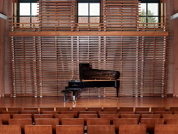 Interior of Chamber Hall (S102) with a grand piano on a polished wooden stage